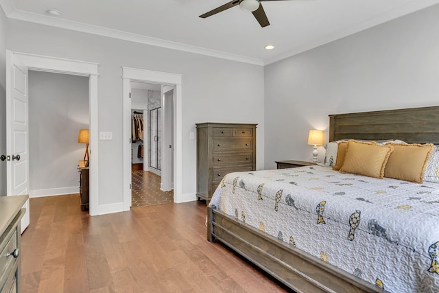 bedroom featuring ceiling fan, crown molding, and wood-type flooring