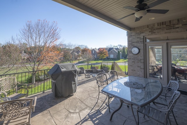 view of patio with area for grilling and ceiling fan