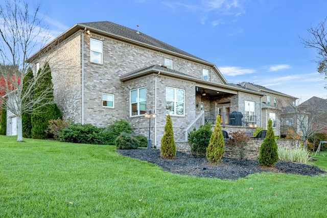 rear view of property with a lawn