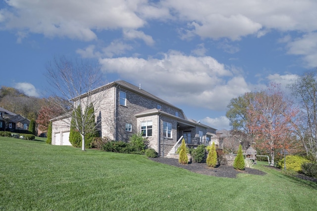 view of home's exterior with a garage and a lawn