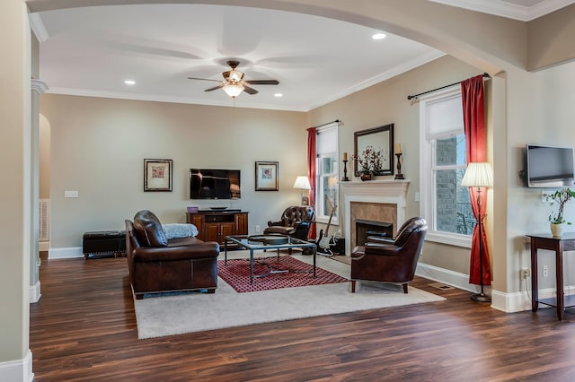 living room with dark hardwood / wood-style floors, ceiling fan, and ornamental molding