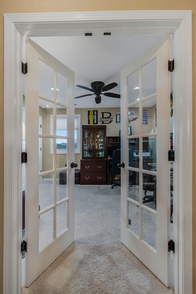 interior space with ceiling fan and french doors