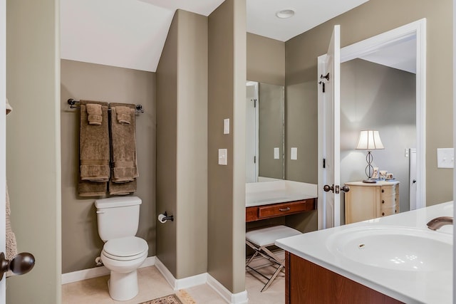 bathroom featuring tile patterned floors, vanity, and toilet