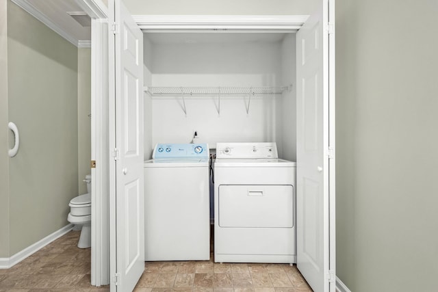 laundry area with crown molding and washer and clothes dryer