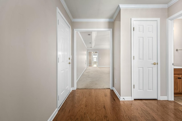 corridor with hardwood / wood-style floors and ornamental molding