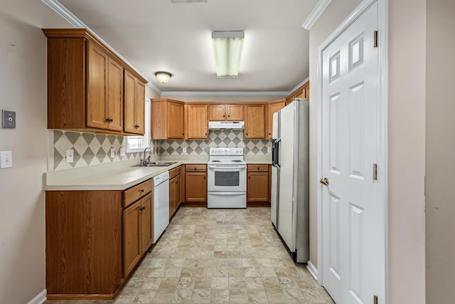 kitchen with decorative backsplash, white appliances, sink, and ornamental molding