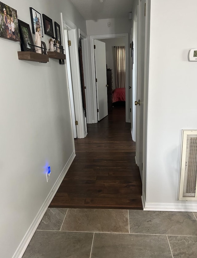 corridor with dark hardwood / wood-style flooring