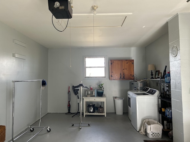 washroom with water heater and independent washer and dryer