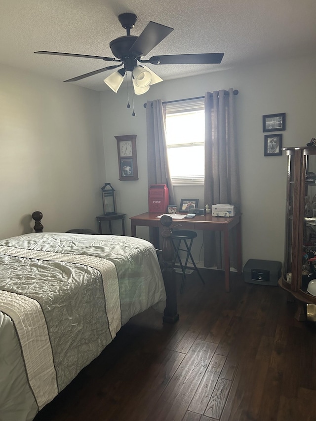 bedroom featuring ceiling fan, dark hardwood / wood-style floors, and a textured ceiling