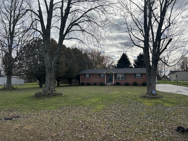 ranch-style home with a front lawn