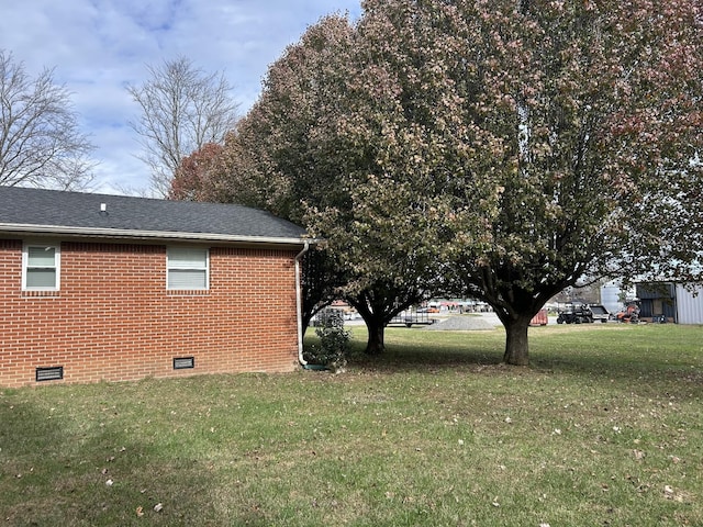 view of side of home featuring a lawn