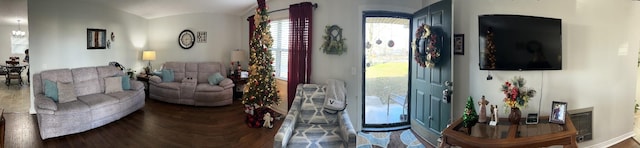 living room featuring a chandelier and lofted ceiling