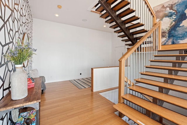 stairway with hardwood / wood-style floors