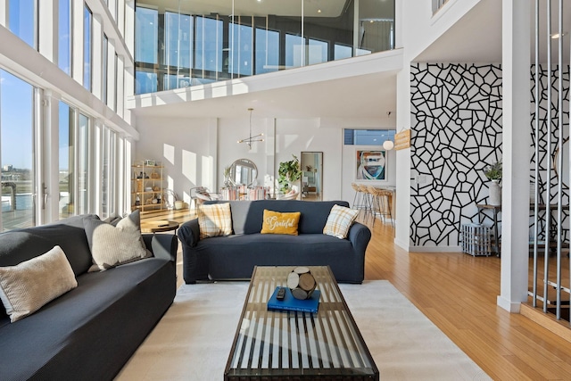 living room with a high ceiling and hardwood / wood-style flooring