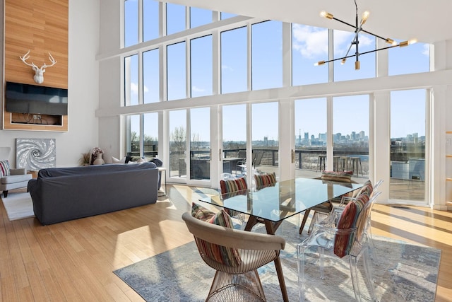 sunroom featuring plenty of natural light and a notable chandelier