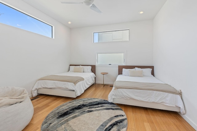 bedroom with wood-type flooring and ceiling fan