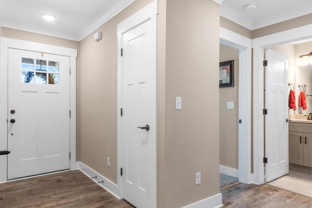 entrance foyer with crown molding and wood-type flooring