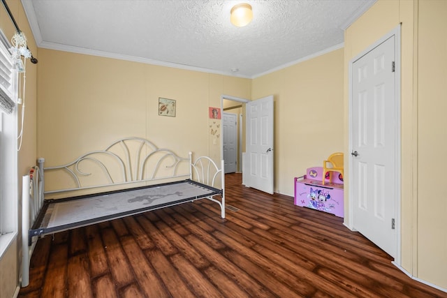 bedroom with dark hardwood / wood-style flooring, ornamental molding, and a textured ceiling