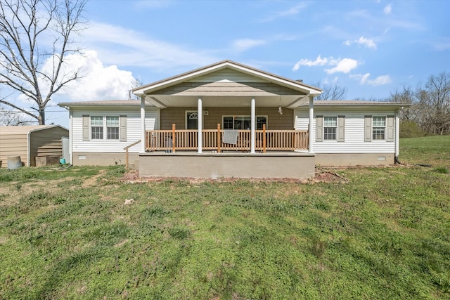 back of property with a porch and a lawn