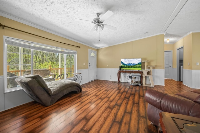 living room featuring a textured ceiling, hardwood / wood-style flooring, ceiling fan, and crown molding