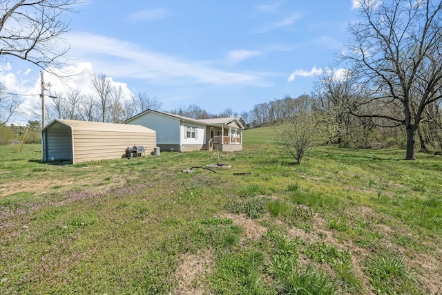 view of yard with a carport and covered porch