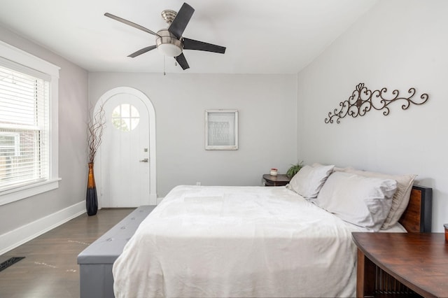 bedroom with dark hardwood / wood-style floors and ceiling fan