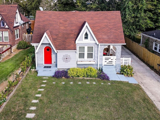 tudor-style house with a front lawn