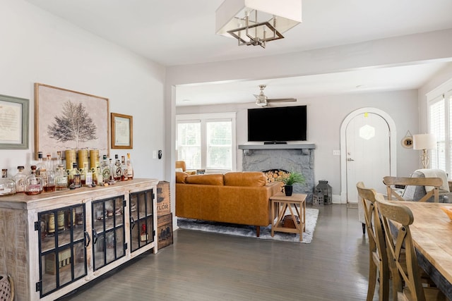 living room featuring dark hardwood / wood-style floors and ceiling fan