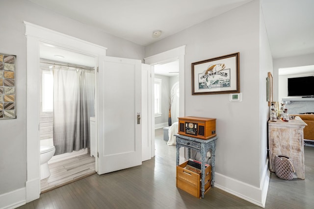 hall with dark wood-type flooring