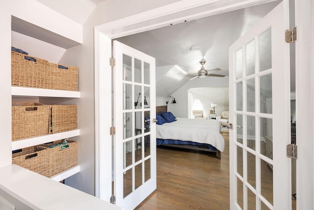 bedroom featuring wood-type flooring, vaulted ceiling, and ceiling fan