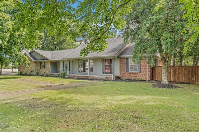 ranch-style home featuring a front yard