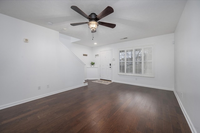 unfurnished room with dark hardwood / wood-style floors and ceiling fan