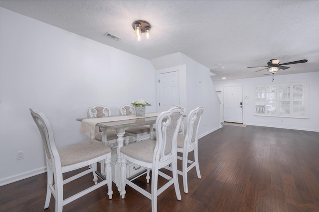 dining room with dark hardwood / wood-style floors, ceiling fan, and a textured ceiling