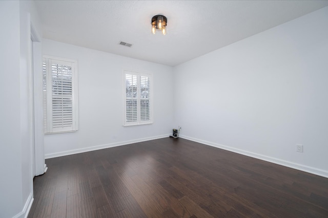 unfurnished room with dark hardwood / wood-style floors