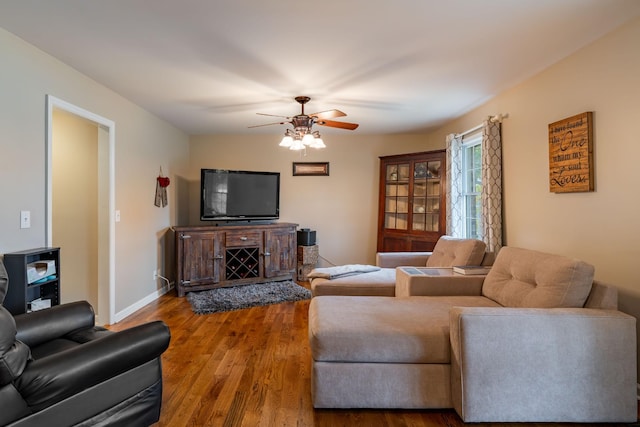 living room featuring hardwood / wood-style floors and ceiling fan