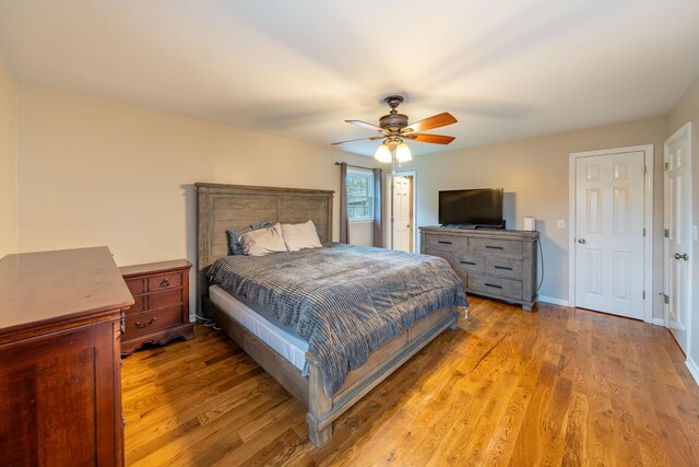 bedroom with ceiling fan and light hardwood / wood-style floors