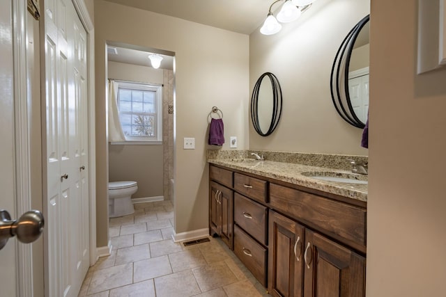 bathroom with tile patterned floors, vanity, and toilet