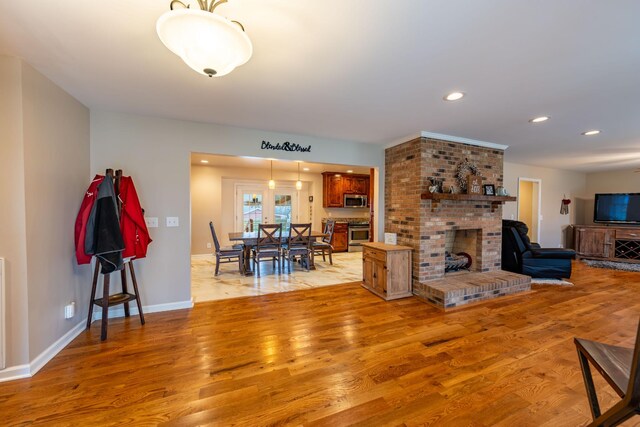 living room with a fireplace and light hardwood / wood-style flooring