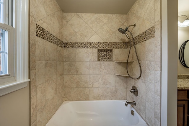 bathroom with vanity and tiled shower / bath