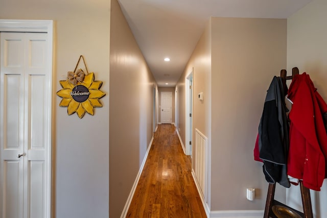 corridor with dark hardwood / wood-style flooring