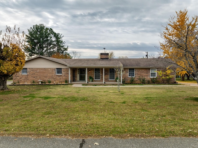 single story home with covered porch and a front yard