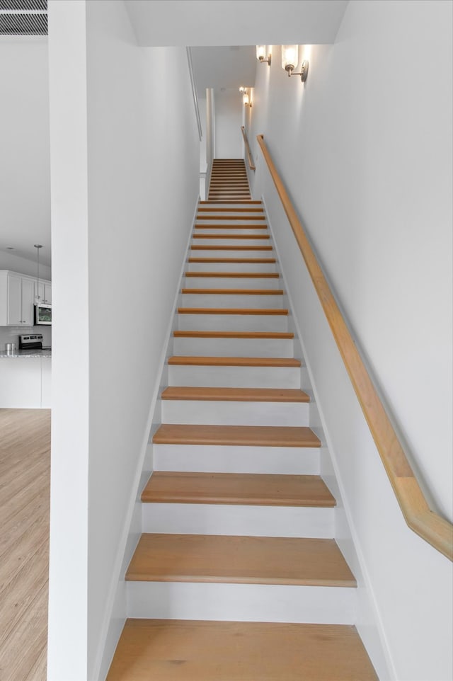 staircase with wood-type flooring