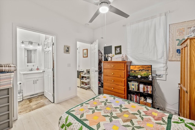 bedroom featuring ensuite bathroom, ceiling fan, light hardwood / wood-style floors, and sink