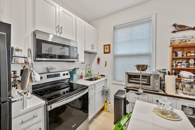 kitchen featuring white cabinets, sink, and stainless steel appliances