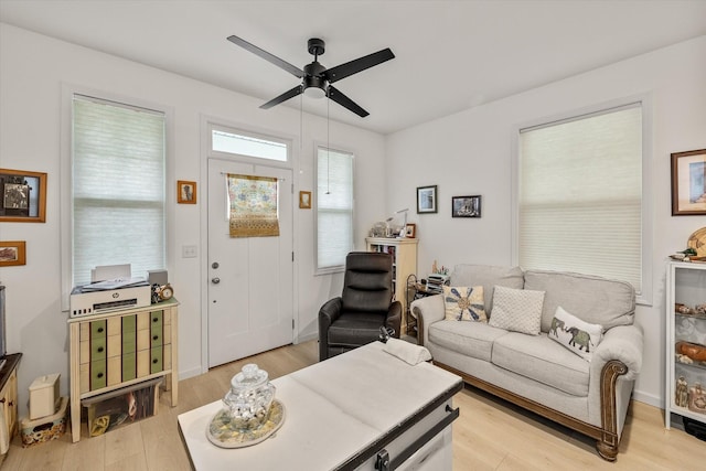 living room featuring light hardwood / wood-style flooring and ceiling fan