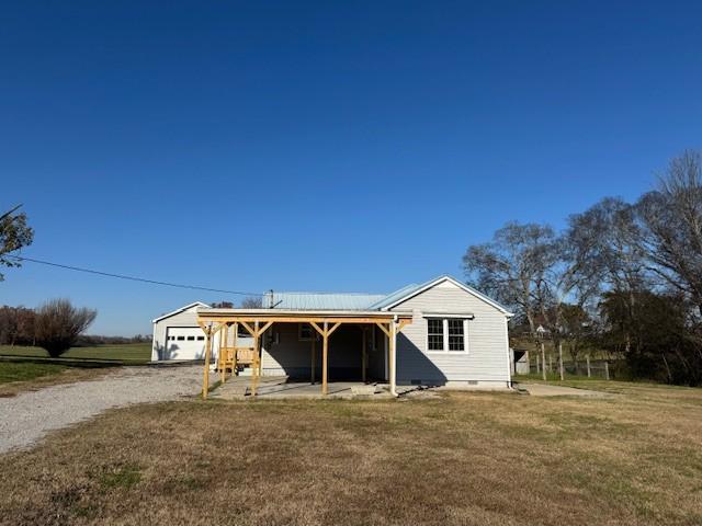 view of front of house with a garage and a front lawn