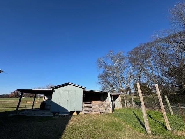 view of home's exterior with an outdoor structure