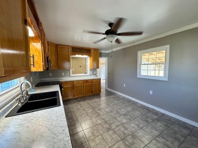 kitchen with black range with electric stovetop, crown molding, sink, tile patterned flooring, and ceiling fan