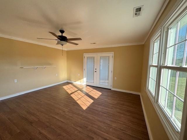 unfurnished room with dark hardwood / wood-style floors, a wealth of natural light, and french doors