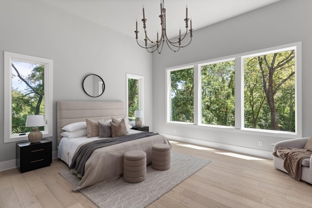 bedroom with multiple windows and light hardwood / wood-style floors